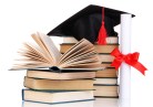 Grad hat with diploma and books isolated on white